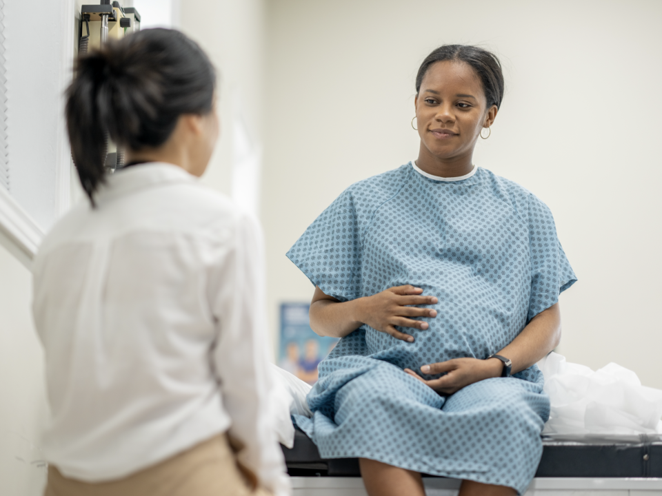 Pregnant woman talking to her doctor