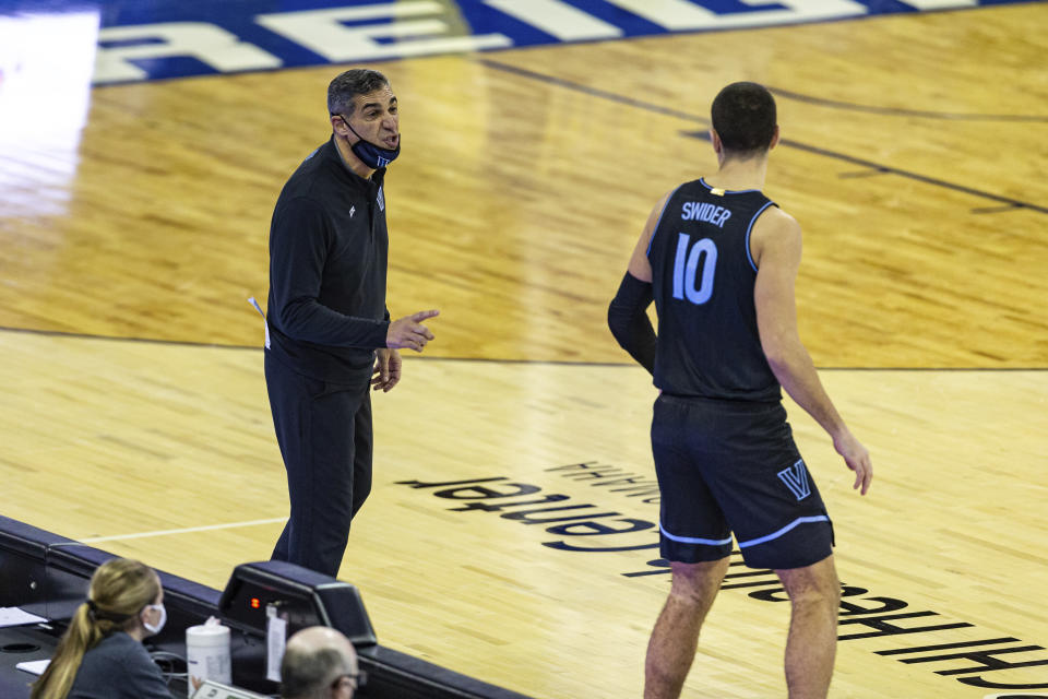 Villanova head coach Jay Wright, left, gives forward Cole Swider (10) instructions before Swider goes in to play against Creighton in the second half during an NCAA college basketball game Saturday, Feb. 13, 2021, in Omaha, Neb. (AP Photo/John Peterson)