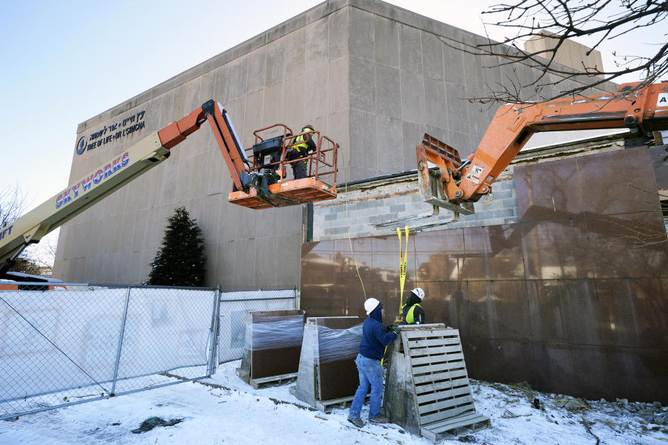 Workers begin demolition Wednesday, Jan. 17, 2023, at the Tree of Life building in Pittsburgh, the site of the deadliest antisemitic attack in U.S. history, as part of the effort to reimagine the building to honor the 11 people who were killed there in 2018. The demolition work began slowly, with crews picking away at the building's exterior. Most the building will be removed, although portions of the sanctuary walls will be preserved. (AP Photo/Gene J. Puskar)