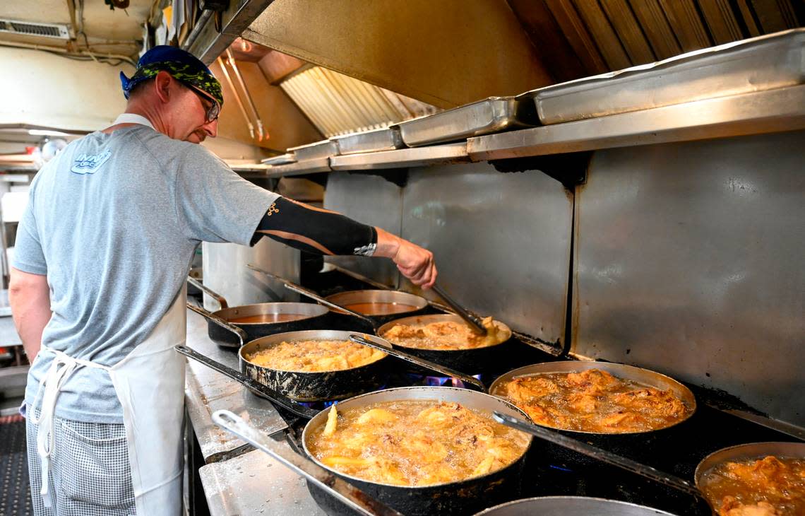 As he has the past 30 years, Andy Myers uses tongs to check the chicken frying in hot oil at Stroud’s in the Northland. “I don’t get tired of it,” said Myers. “I’ll eat fried chicken every day, but I’m not going to KFC to get it.” 