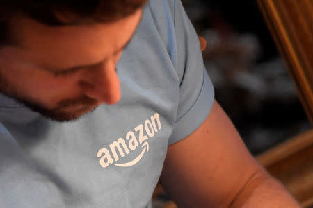 A worker wears a branded T-shirt inside Amazon's Black Friday pop-up space in London, Britain, November 21, 2017. REUTERS/Toby Melville