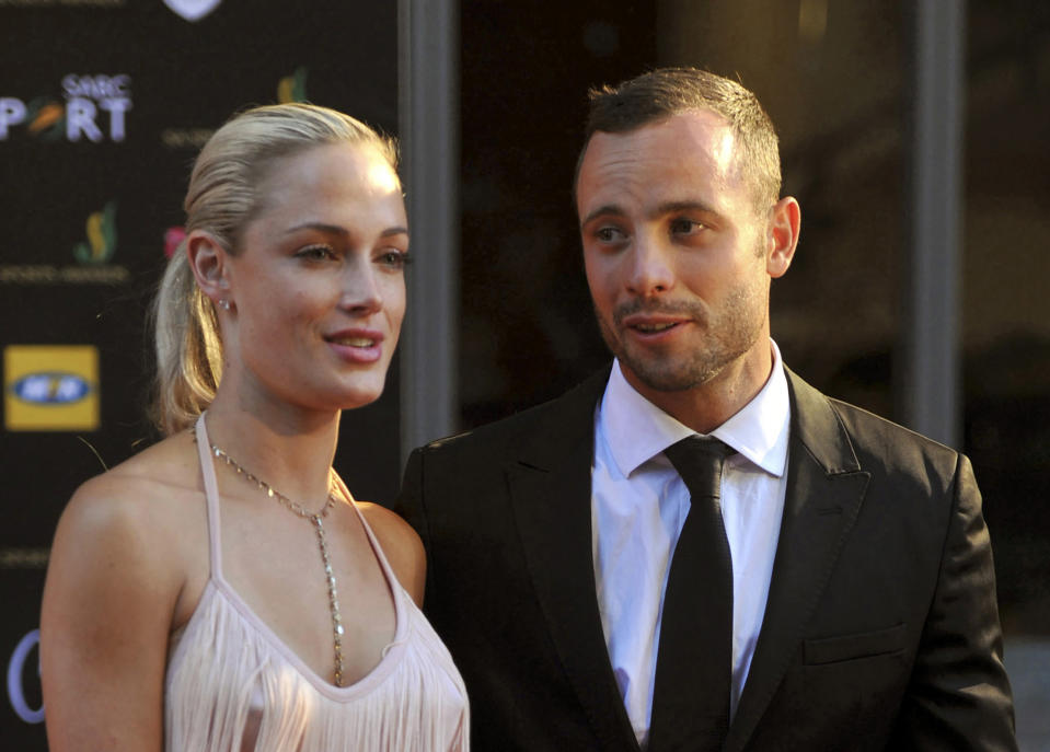 FILE - South African Olympic athlete Oscar Pistorius, right, and his girlfriend, the late Reeva Steenkamp, left, arrive at an awards ceremony in Johannesburg, South Africa. Nov. 4, 2012. Eight years after he shot dead his girlfriend, Pistorius is up for parole, but first he must meet with her parents as part of the parole procedure. A parole hearing for Pistorius was scheduled for last month and then canceled, partly because a meeting between Pistorius and Steenkamp's parents, Barry and June, had not been arranged, lawyers for both parties told The Associated Press on Monday, Nov. 8, 2021. (Lucky Nxumalo/Citypress via AP, File)