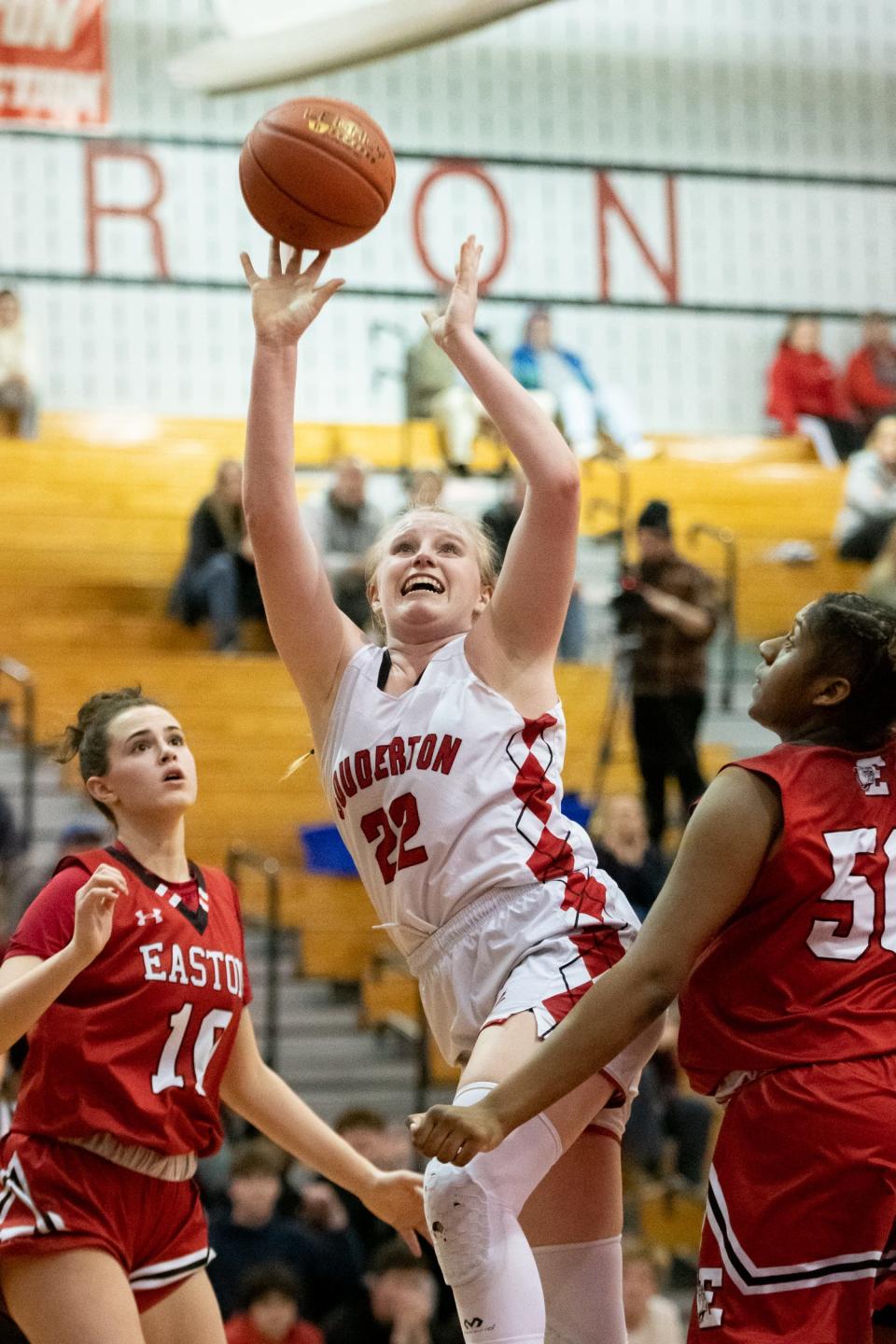 Souderton's Teya McConnaha, center, shoots while covered by Easton's Evalyse Cole, left, and Anye Staton in a PIAA 6A first round state playoff game against Easton, on Tuesday, March 8, 2022, at Souderton High School. The Red Rovers defeated Big Red 42-36 to advance to the second round.