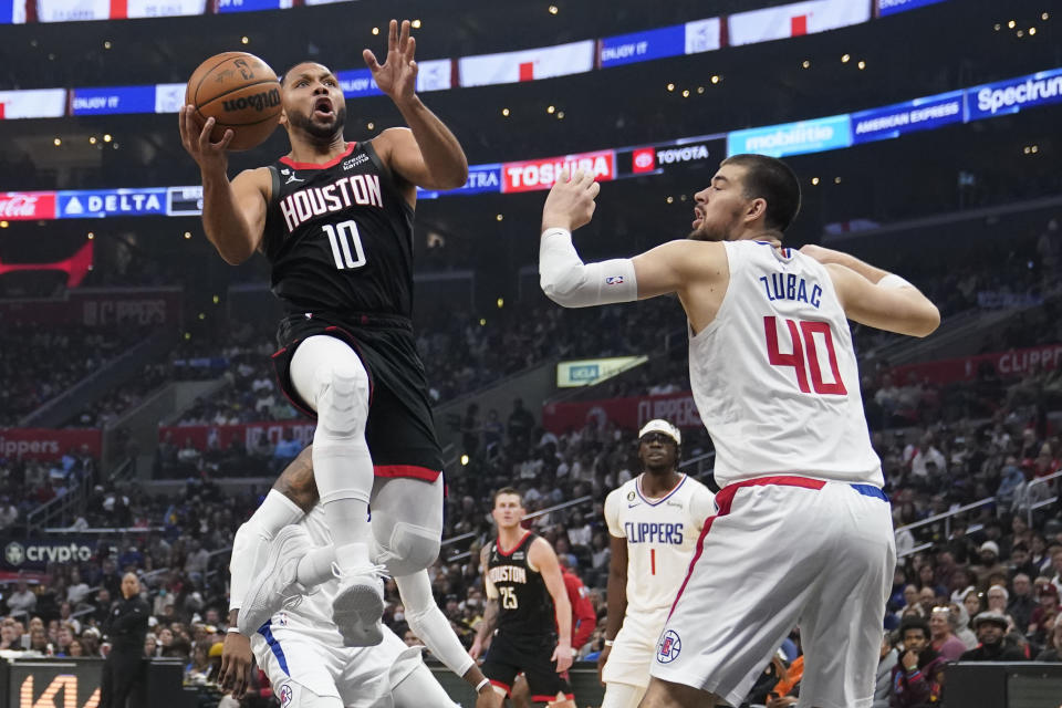 Houston Rockets guard Eric Gordon (10) scores past Los Angeles Clippers center Ivica Zubac (40) during the first half of an NBA basketball game Sunday, Jan. 15, 2023, in Los Angeles. (AP Photo/Marcio Jose Sanchez)