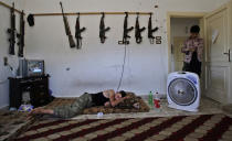 <p>A Syrian rebel, sleeps after returning back from fighting against Syrian army forces in Aleppo, at a rebel headquarters in Marea on the outskirts of Aleppo city, Syria, Aug. 26, 2012. (Photo: Muhammed Muheisen/AP) </p>