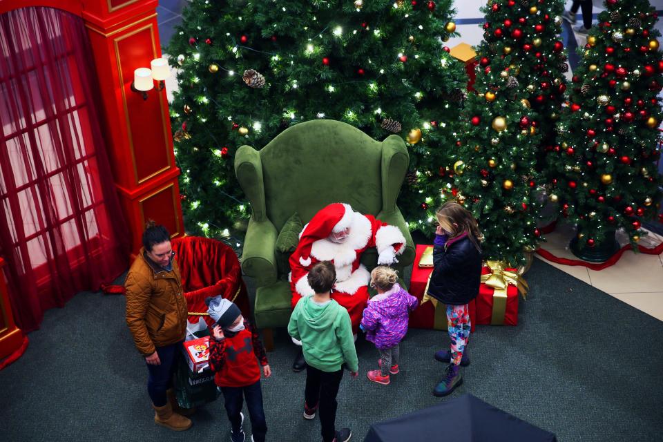 Holiday shoppers weren’t the only ones at Mayfair mall in November 2021. A family pays a visit to Santa in between shopping at the mall.