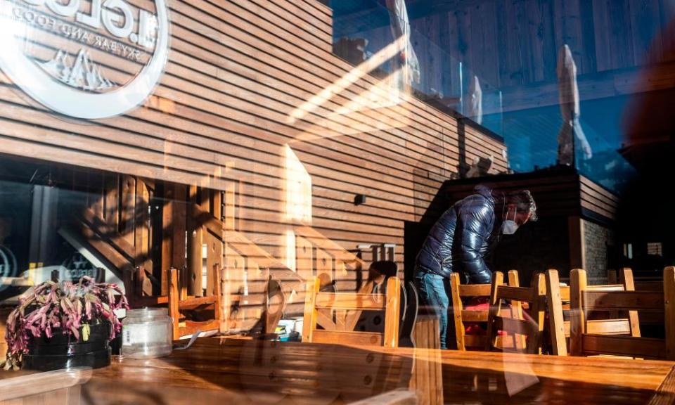 A restaurant owner carries out maintenance in Sestriere.