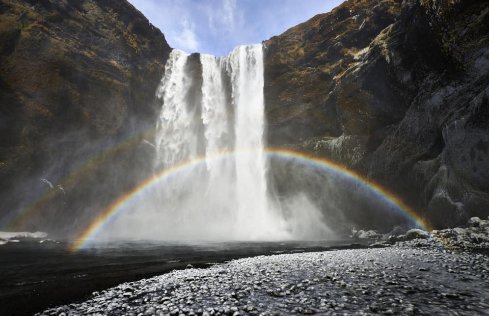 A rainbow appears in front of a waterfall in Iceland. (Michael Fersch/Caters News Agency)