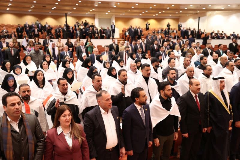 Iraqi lawmakers attend the first session of the new Iraqi parliament in Baghdad