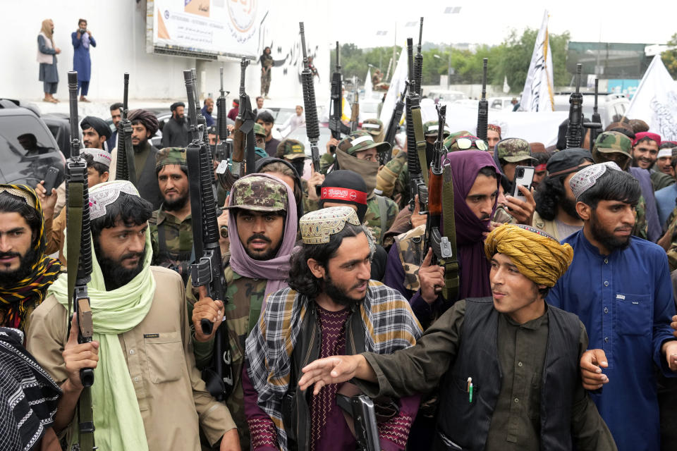 Taliban fighters celebrate one year since they seized the Afghan capital, Kabul, in front of the U.S. Embassy in Kabul, Afghanistan, Monday, Aug. 15, 2022. The Taliban marked the first-year anniversary of their takeover after the country's western-backed government fled and the Afghan military crumbled in the face of the insurgents' advance. (AP Photo/Ebrahim Noroozi)