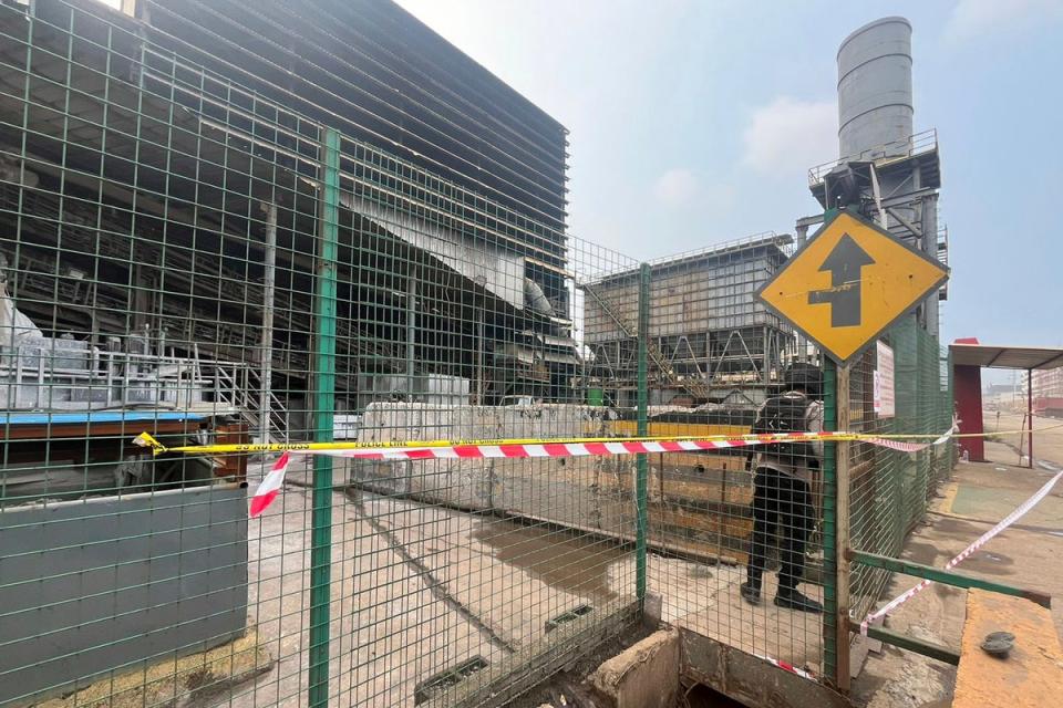 A police officer stands guard near the site where a furnace explosion occurred at PT Indonesia Tsingshan Stainless Steel smelting plant in Morowali, Central Sulawesi (AP)