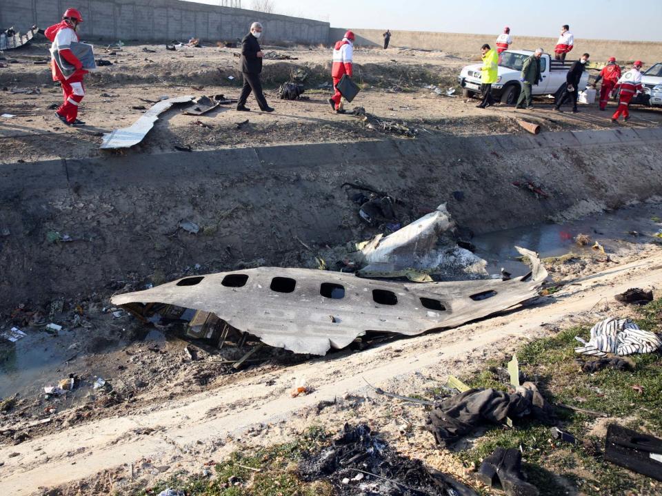 Officials stand near the wreckage after an Ukraine International Airlines Boeing 737-800 which crashed shortly after take-off near Tehran, killing all 176 people on board, 8 January, 2020: Abedin Taherkenareh/EPA