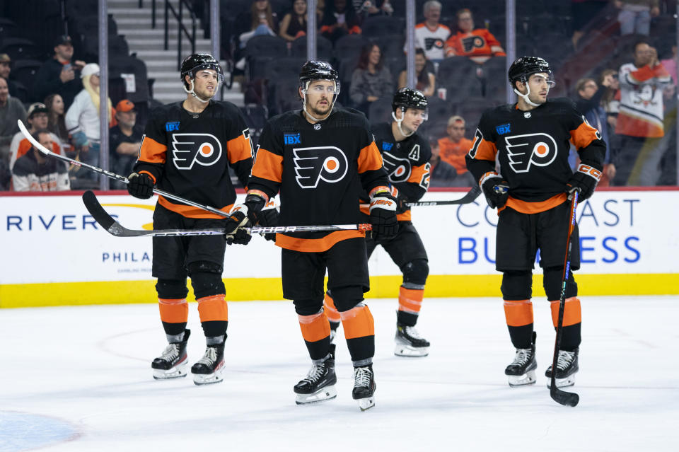 Philadelphia Flyers' Travis Konecny, center left, looks on with his teammates after losing their first home game of the season following the NHL hockey game against the Anaheim Ducks, Saturday, Oct. 28, 2023, in Philadelphia. The Ducks won 7-4. (AP Photo/Chris Szagola)