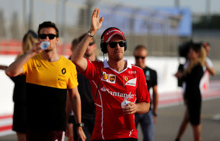 Formula One - F1 - Bahrain Grand Prix - Sakhir, Bahrain - 16/04/17 - Ferrari Formula One driver Sebastian Vettel of Germany waves at fans during the drivers parade at the Bahrain F1 Grand Prix. REUTERS/Hamad I Mohammed