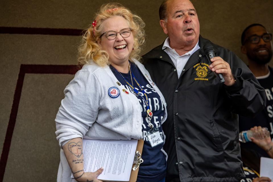Lisa Vergos, 58, of Warren, Mich., speaks on stage with Michigan Teamsters President Kevin Moore during a solidarity rally for Corewell Health East registered nurses, who are banding together to unionize with the Teamsters Council 43, at the Teamster building in Detroit on Friday, May 10, 2024. Vergos recently retired from Corewell, but helped lead the unionization effort.
