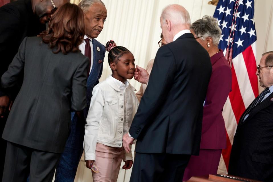 U.S. President Joe Biden (right) and U.S. Vice President Kamala Harris (left) speak to Gianna Floyd, the daughter of George Floyd, as the Rev. Al Sharpton (center) looks on at the White House on May 25, 2022, in Washington, D.C. (Photo by Anna Moneymaker/Getty Images)