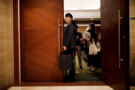 A jobseeker stands as he gets into the 2018 Japan Job Fair in Seoul, South Korea, November 7, 2018. Picture taken on November 7, 2018. REUTERS/Kim Hong-Ji