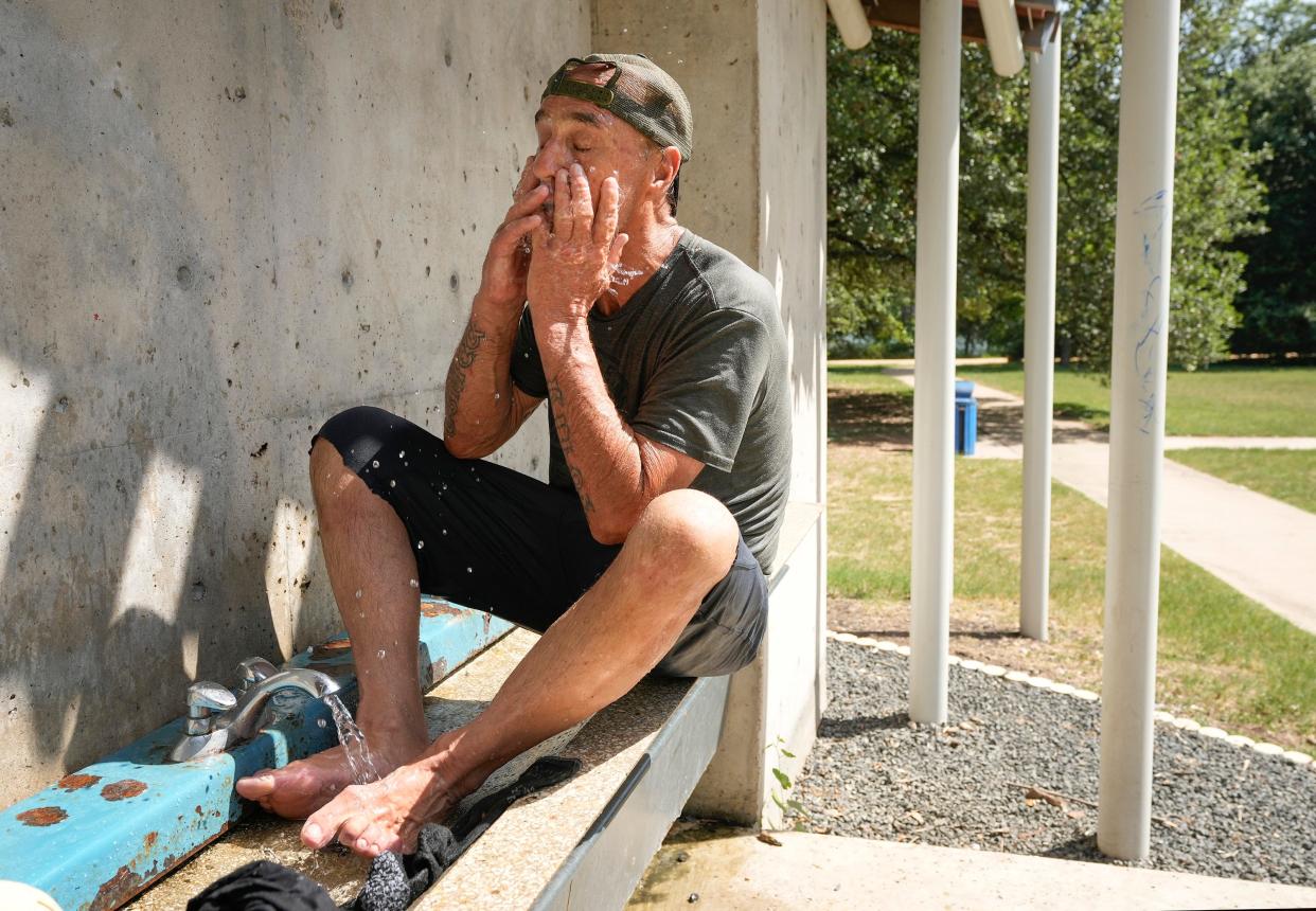 Glen Garner, who is homeless, tries to cool off in the 99-degree heat in Edward Rendon Sr. Park at Festival Beach on Monday July 1, 2024. “It’s tough,” he said of trying to survive the extreme heat.