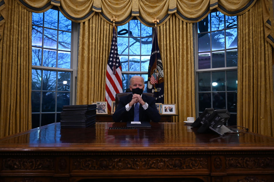 President Joe Biden sits in the Oval Office at the White House, after being sworn in.<span class="copyright">Jim Watson—AFP/Getty Images</span>