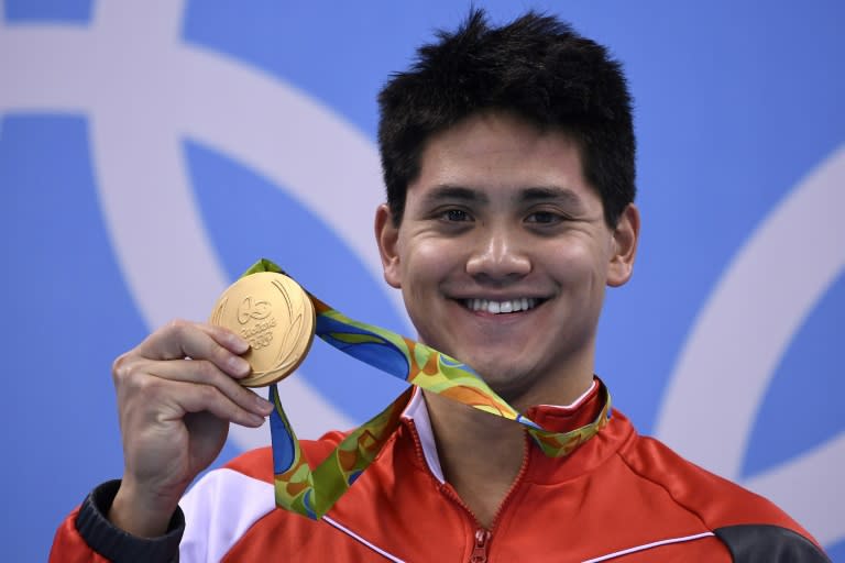 Singapore's Joseph Schooling with his gold medal after beating Michael Phelps to win the 100m butterfly at the Rio Olympics in 2016 (GABRIEL BOUYS)