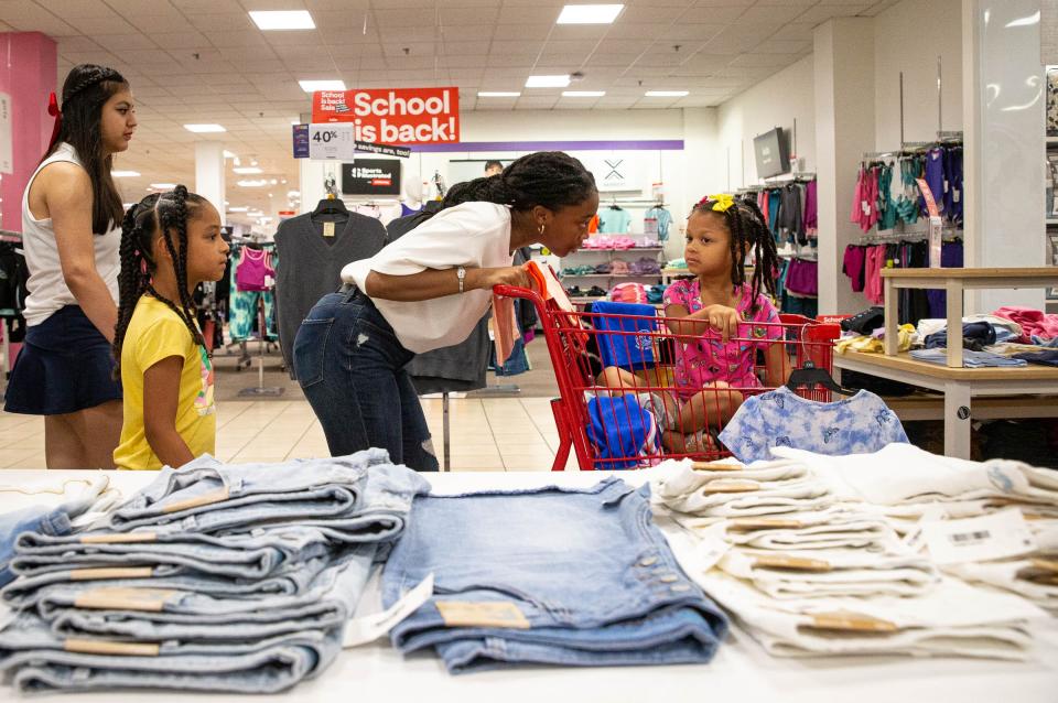 West Oso High School senior Alaejah Reed, center, and Incarnate Word Academy junior Isabella Cuevas, left, shop with 4- and 7-year-old John F. Kennedy Elementary students at JCPenney in La Palmera shopping mall on Wednesday, Aug. 17, 2022, in Corpus Christi, Texas.