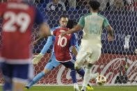 FC Dallas forward Jesus Ferreira (10) scores against Austin FC goalkeeper Brad Stuver, center left, during the second half of an MLS soccer match Saturday, May 11, 2024, in Frisco, Texas. (AP Photo/LM Otero)