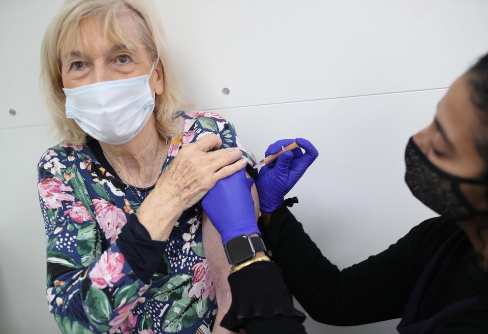 <p>Pharmacist Asha Fowells vaccinates  Catherine Jinadu, aged 82, with her second dose of the Oxford/AstraZeneca coronavirus vaccine, at Copes Pharmacy and Travel Clinic in Streatham, south London.</p> (PA)