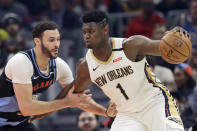 New Orleans Pelicans' Zion Williamson (1) drives past Cleveland Cavaliers' Larry Nance Jr. during the first half of an NBA basketball game Tuesday, Jan. 28, 2020, in Cleveland. (AP Photo/Tony Dejak)