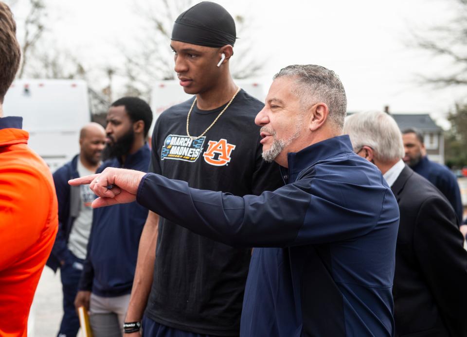 Auburn's Jabari Smith (center) and head coach Bruce Pearl talk as the team arrives at Bon Secours Wellness Arena in Greenville, S.C., on March 18.