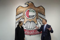 UAE Minister of State for Food and Water Security Mariam al-Muhairi, left, listens to Erel Margalit, founder and chairman of Jerusalem Venture Partners, at the headquarter of the Government Accelerators in Dubai, United Arab Emirates, Tuesday, Oct. 27, 2020. Another plane full of Israeli business people excited about their newfound access to the UAE has touched down in Dubai this week. It's the latest whirlwind trip seeking to cash in on a U.S.-brokered deal to normalize relations between the countries. (AP Photo/Kamran Jebreili)