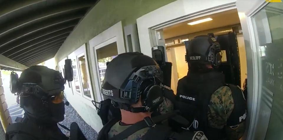 GPD SWAT unit officers enter Colliers International offices in Gainesville on June 2 to execute a search warrant, image taken from police camera video.