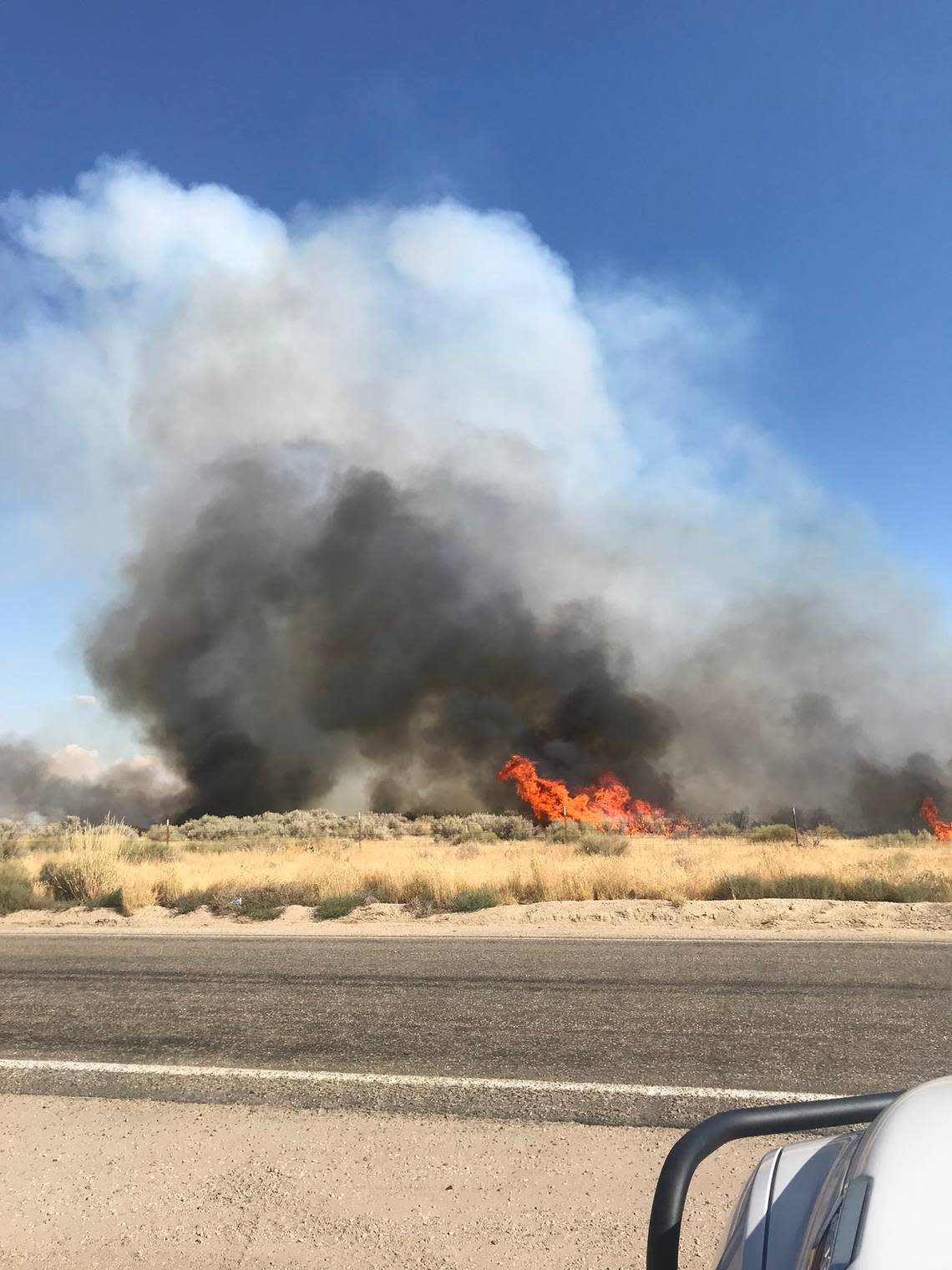 The grass and brush fire, which was contained by 8 p.m. Monday, ballooned to over 700 acres.