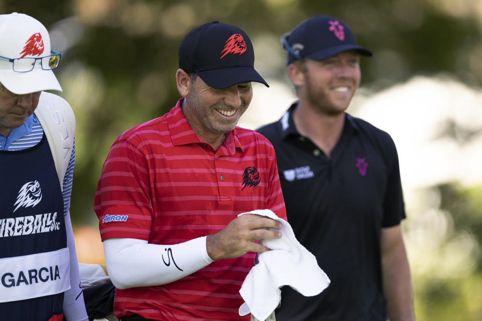 Sergio Garcia, center, and Talor Gooch smile on the fifth hole during the final round of LIV Golf Singapore at Sentosa Golf Club on Sunday, April 30, 2023, on Sentosa Island in Singapore. (Doug DeFelice/LIV Golf via AP)