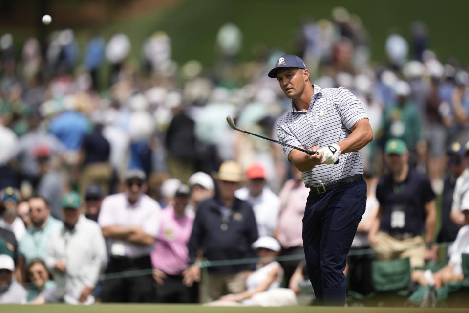 Bryson DeChambeau chips to the green on the seventh hole during the first round at the Masters golf tournament at Augusta National Golf Club Thursday, April 11, 2024, in Augusta, Ga. (AP Photo/Charlie Riedel)