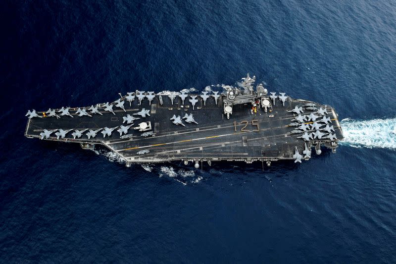 FILE PHOTO: Chief Petty Officers stand in formation on the flight deck of the U.S. Navy aircraft carrier USS Theodore Roosevelt