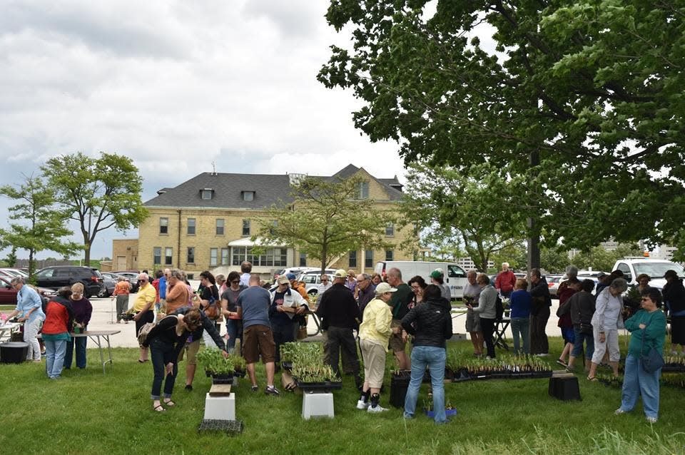 Buyers mill about at a previous Friends of the Monarch Trail plant sale at the Milwaukee County Parks Administration Building. This year's sale has been moved to the Greenfield Park Pavilion.