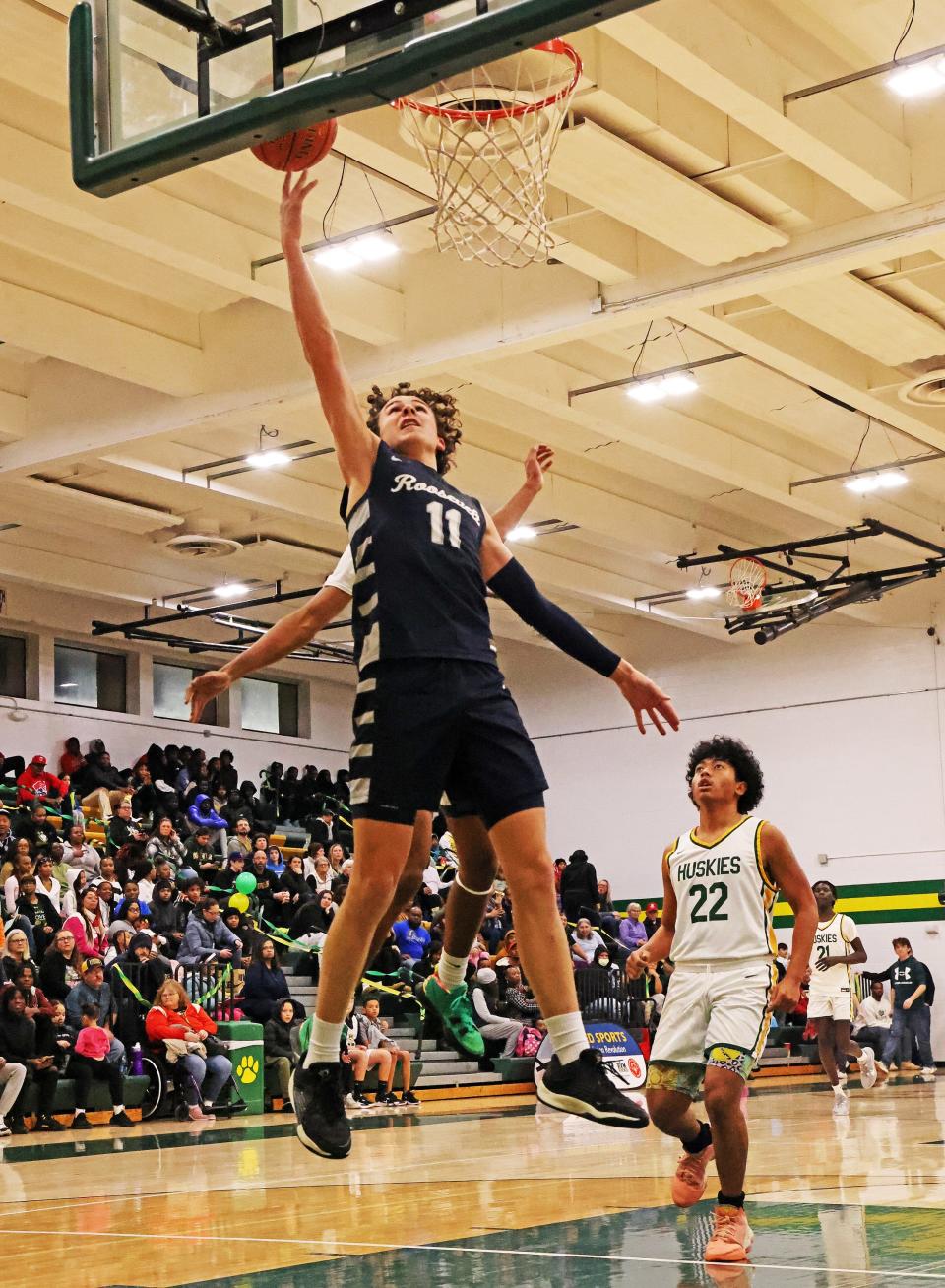 Charlie King (11) drives to the hoop as the Roosevelt Roughriders compete against the Hoover Huskies.