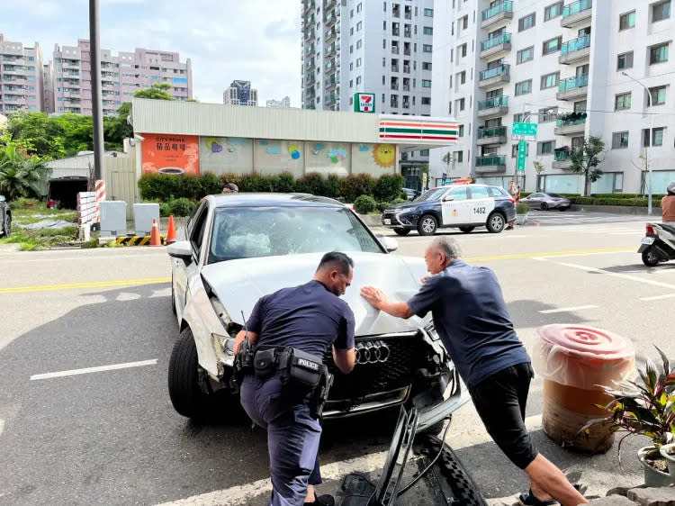 員警採證後，徒手推出肇事的白色奧迪。讀者提供
