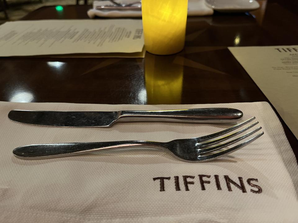 Plate setting with napkin that has Tiffins name embedded on it.