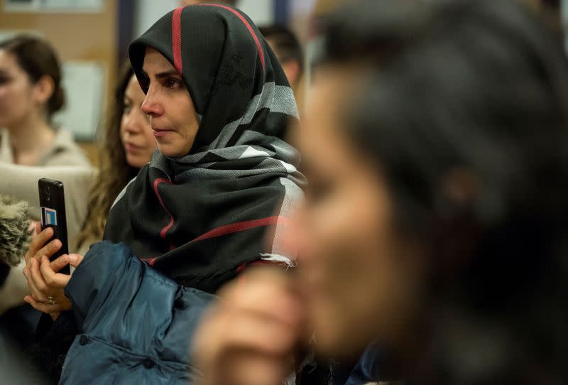 Mourners attend a vigil in memory of Iranian student Amir Moradi in Kingston