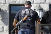 FILE - A man carries his weapon during a second amendment gun rally at Utah State Capitol on Feb. 8, 2020, in Salt Lake City. Utah is one of several more states weighing proposals this year that would allow people to carry concealed guns without having to get a permit, a trend supporters say bolsters Second Amendment rights but is alarming to gun-control advocates. (AP Photo/Rick Bowmer, File)