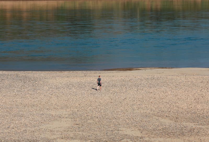 FILE PHOTO: Tourist walks on the Mekong river bank outside Loei