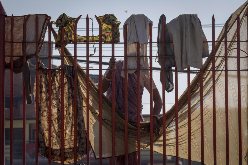 An Indian pilgrim hangs her clothes to dry after completing her visit to Pashupatinath temple in Kathmandu, Nepal, Jan. 5, 2024. The centuries-old temple is one of the most important pilgrimage sites in Asia for Hindus. Nepal and India are the world’s two Hindu-majority nations and share a strong religious affinity. Every year, millions of Nepalese and Indians visit Hindu shrines in both countries to pray for success and the well-being of their loved ones. (AP Photo/Niranjan Shrestha)