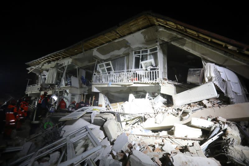 Rescuers work on a collapsed building after an earthquake in Elazig