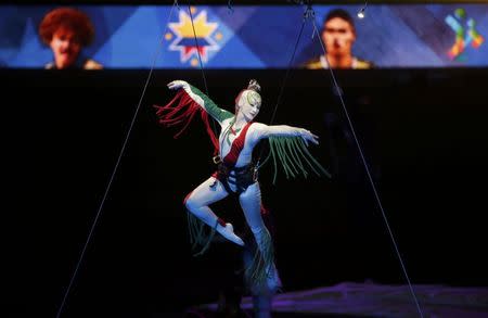 A performer dangles from a balloon during the Opening Ceremonies of the Copa America 2015 soccer tournament at the National Stadium in Santiago, Chile June 11, 2015. REUTERS/Ueslei Marcelino