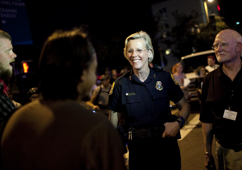 TAMPA, FL - AUGUST 29:   Protesters speak with Tampa Police Chief Jane Castor (2ndR) while marching during the Republican National Convention on August 29, 2012 in Tampa, Florida. The marchers remained peaceful and were allowed to make their own route through downtown.  (Photo by Edward Linsmier/Getty Images)