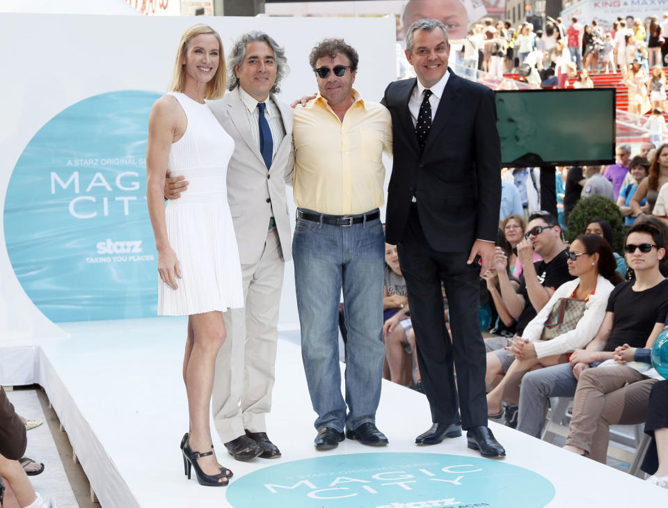 This publicity image released by Starz shows the cast of the series "Magic City", from left, Kelly Lynch, show creator, Mitch Glazer, Michael Rispoli, and Danny Huston in Times Square on New York, June 12, 2013 to promote the season two premiere airing Friday, June 14 at 9 p.m. on Starz. (AP Photo/Starz, Stuart Ramson)