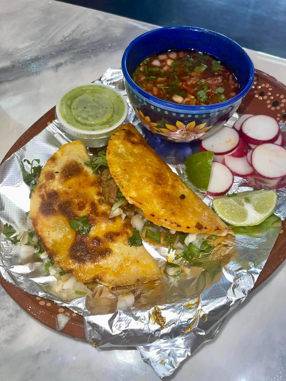 Birria tacos with a bowl of consome, the liquid the birria meat cooks in, for dipping served up at Taqueria la Pina Loka in Warner Robins.