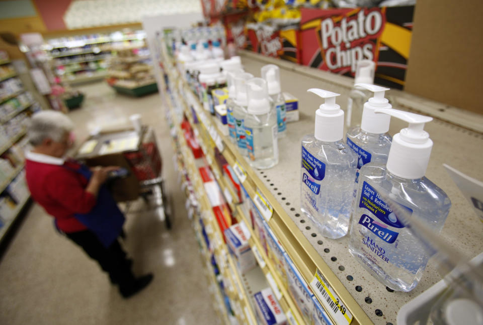 Bottles of Purell hand sanitizer sit on display as a worker stocks shelves at a local Dahl's grocery store, Wednesday, April 29, 2009, in Des Moines, Iowa. (AP Photo/Charlie Neibergall)