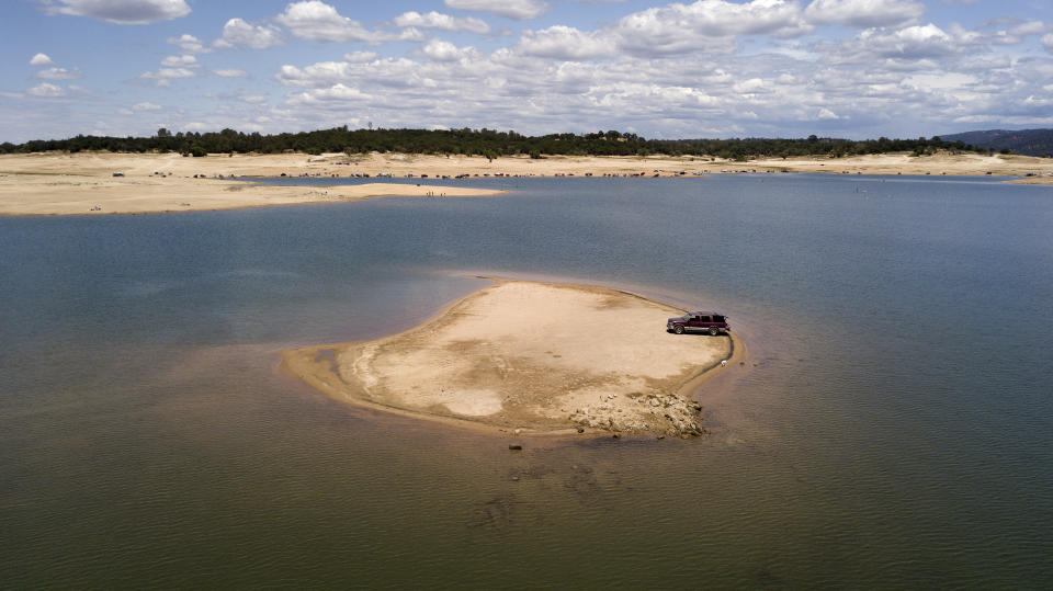 William Heinz parks his vehicle on a newly revealed piece of land due to receding waters at the drought-stricken Folsom Lake in Granite Bay, Calif., Saturday, May 22, 2021. California Gov. Gavin Newsom declared a drought emergency for most of the state. (AP Photo/Josh Edelson)